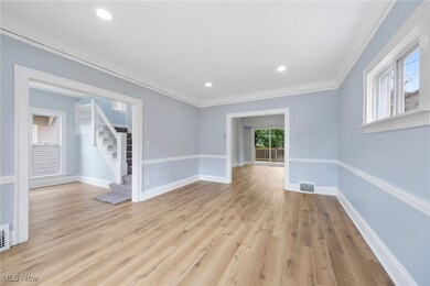 Unfurnished room with light hardwood / wood-style flooring and ornamental molding