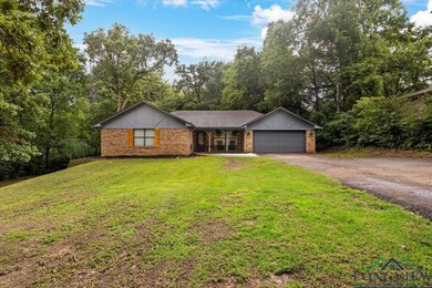 Single story home featuring brick siding, covered 