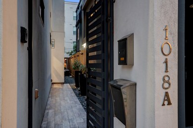 A gated entry with video intercom controls invites