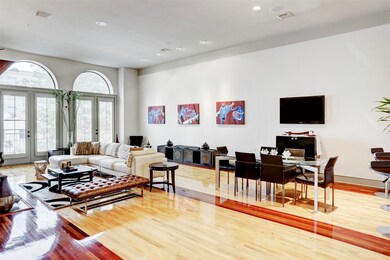 Living and dining room area. Balcony doors with shutters overlooking the courtyard. Located on 2nd floor.