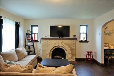 Hardwood floors and fireplace compliment the livin