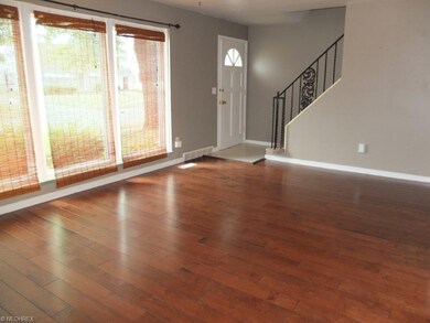 Spacious formal living room with wood flooring.