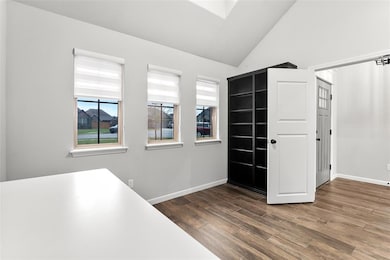 Unfurnished office with baseboards, vaulted ceilin