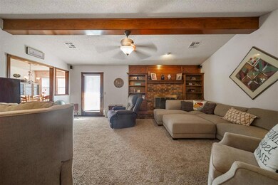 Living room featuring ceiling fan with notable cha