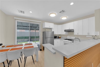 Kitchen featuring under cabinet range hood, stainl