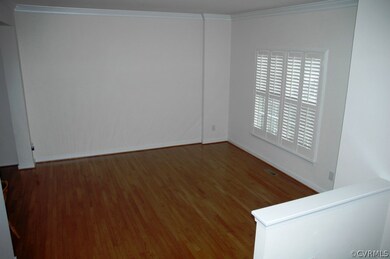 Living room with hardwood floor, crown moulding &