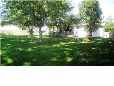 Beautifully landscaped backyard with deck, pergola