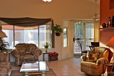 Living room with tile, ceiling fan