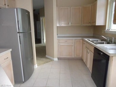 Kitchen with ceramic tile flooring, refrigerator, 