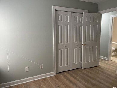 Unfurnished bedroom with a closet, baseboards, ens