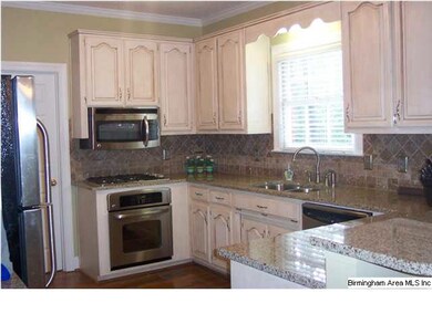 Updated kitchen includes granite countetops, tile 