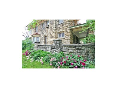 Wrap around porch showcasing excellent stone mason