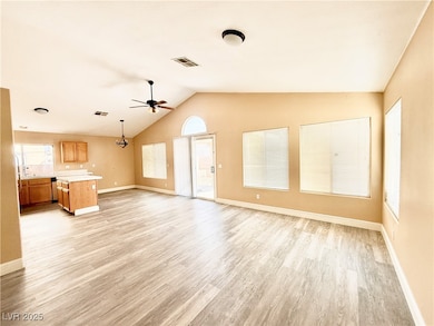 Unfurnished living room with lofted ceiling, light