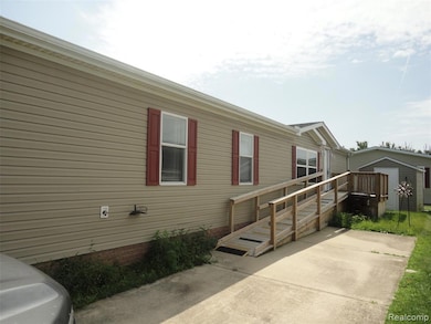 View of home's exterior featuring a shed and a wooden deck