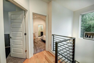 Hallway featuring an upstairs landing, light wood