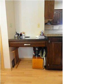 THE KITCHEN INCLUDES A DESK.