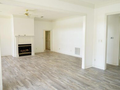 Unfurnished living room with ornamental molding, c