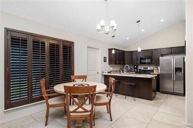 Dining room with light tile patterned floors, a chandelier, recessed lighting, and high vaulted ceiling