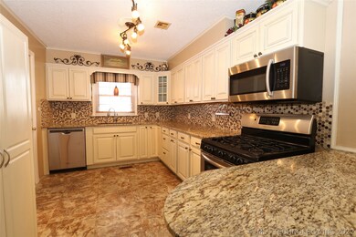 Kitchen has beautiful granite and tile back splash
