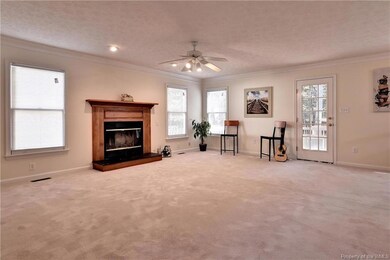 Expansive Family Room with plenty of natural light and wood burning fireplace