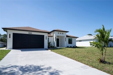 Prairie-style home with a front lawn, an attached