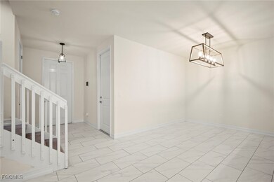 Unfurnished dining area with stairs and a chandeli