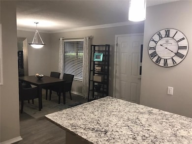 Dining space with dark hardwood / wood-style floor
