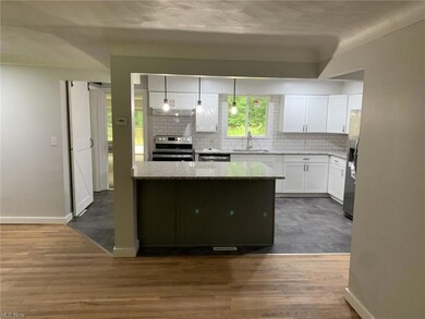 Kitchen with decorative light fixtures, backsplash