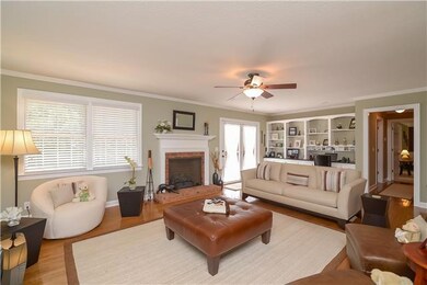 The living room has built-in bookcases with granite top, hardwoods, recessed lighting and gas (or) wood burning fireplace!