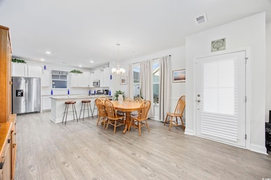 Dining space featuring sink, light hardwood / wood