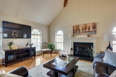 The Gas fireplace has a granite raised hearth and is flanked by 2 arched windows.