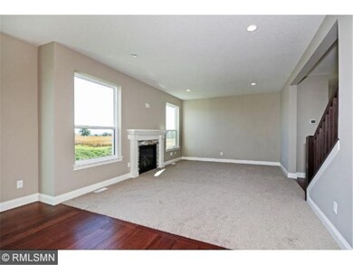 Great room with fireplace and large windows to bri