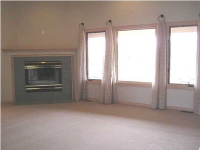 Living room with gas fireplace, lots of natural li