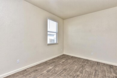 Empty room with baseboards and dark wood finished