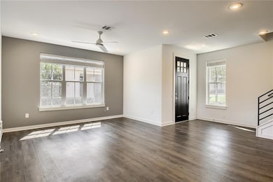 Empty room with recessed lighting, a ceiling fan, and dark wood-style floors