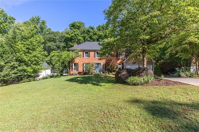 Colonial house with brick siding, a front lawn, a 