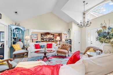 Living room featuring a notable chandelier and hig