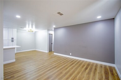 Empty room featuring light wood-style floors, rece