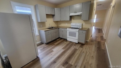 Kitchen featuring white appliances