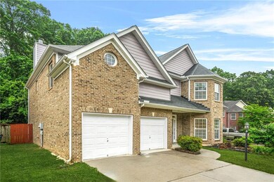View of front of home featuring driveway, a garage