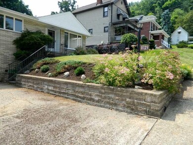 Exterior Front. Retaining wall features fresh land