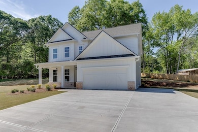 Modern farmhouse featuring fence, a shingled roof,