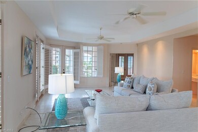 Tiled living room featuring french doors, a tray c