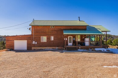 View of front of property featuring a garage and covered porch