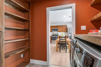 Pantry featuring separate washer and dryer