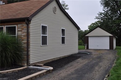 side view and driveway to detached garage