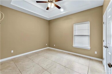 Spare room featuring ceiling fan and a raised ceiling