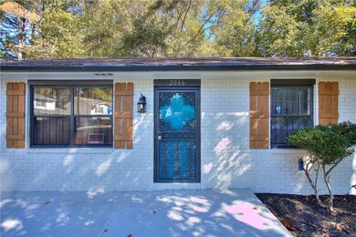 Doorway to property featuring brick siding
