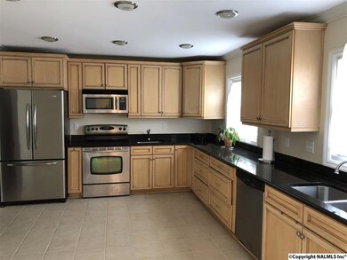 Stainless appliances, granite, tile, and additional prep sink for the chef.