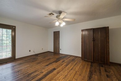 Unfurnished bedroom with two closets, ceiling fan,